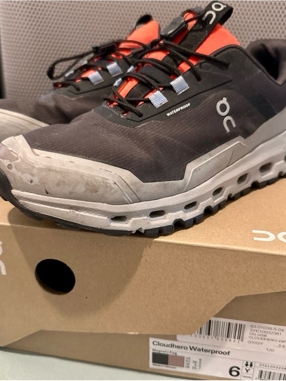 On Cloudhero running shoes, waterproof in size 6Y -black, gray and orange accent
